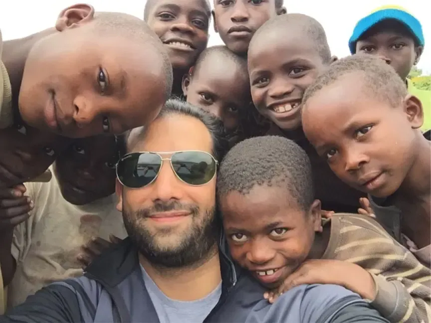 Ali Nasser with children supported by the Wealth with Purpose® Foundation